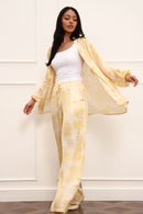 Woman wearing a yellow outfit with a white background