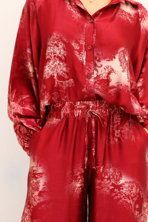 Red patterned outfit on a plain background