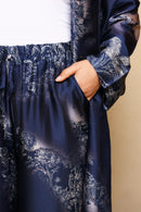 Navy blue floral-patterned dress with a beige background