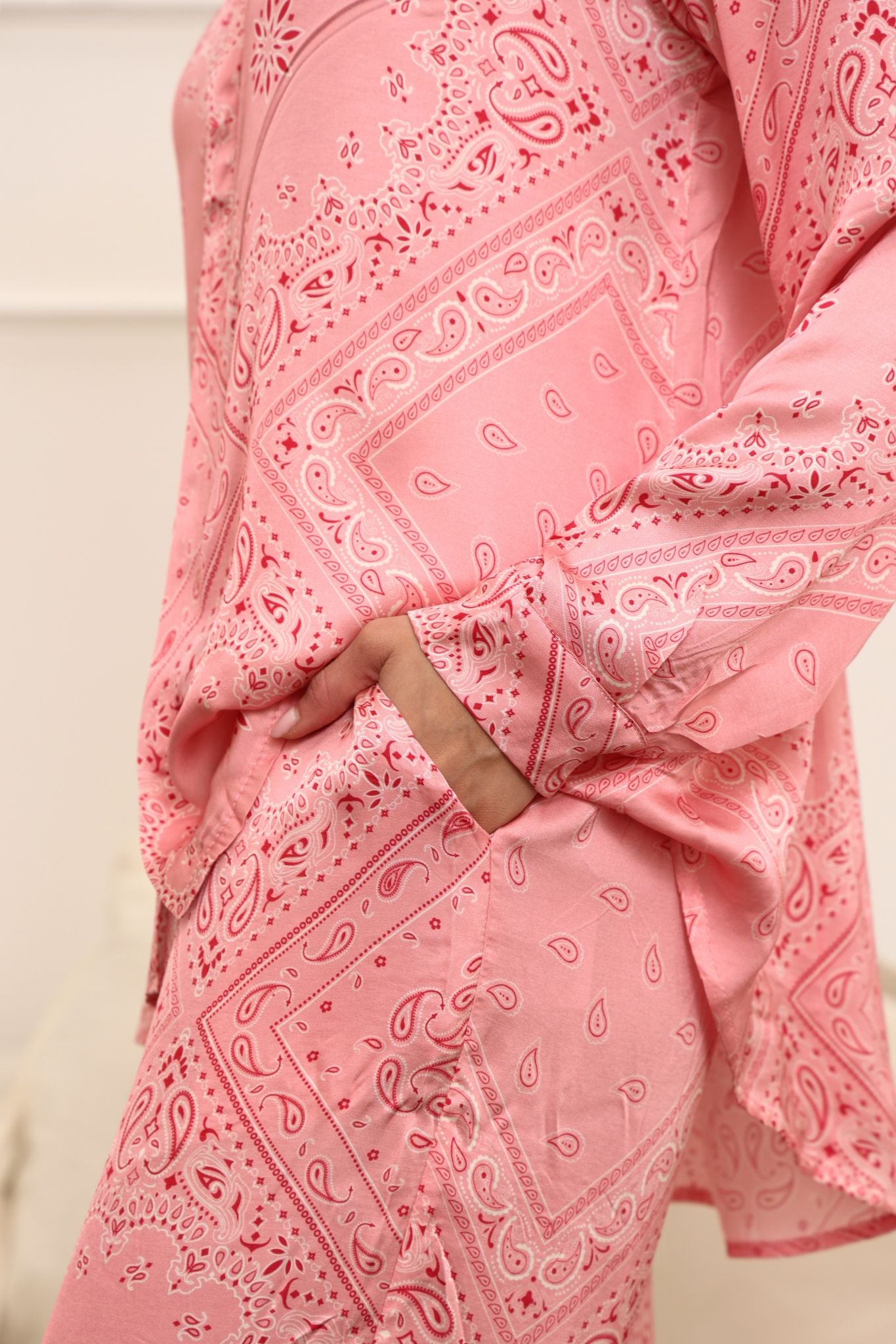 Pink bandana set with paisley patterns on a plain background