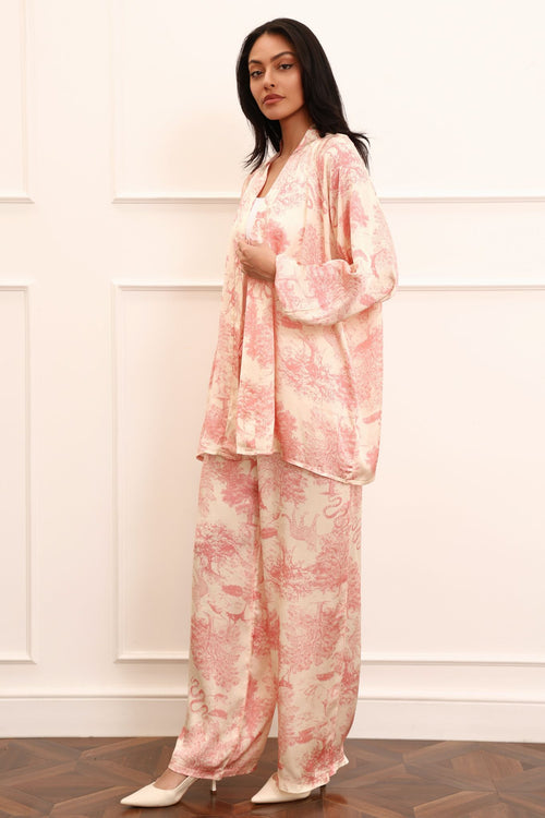 Woman wearing a pink kimono set against a white background