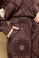 Close-up of a brown patterned garment with intricate designs.