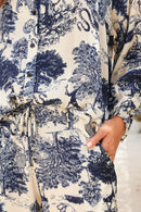 Close-up of a patterned garment with blue and black design on a neutral background