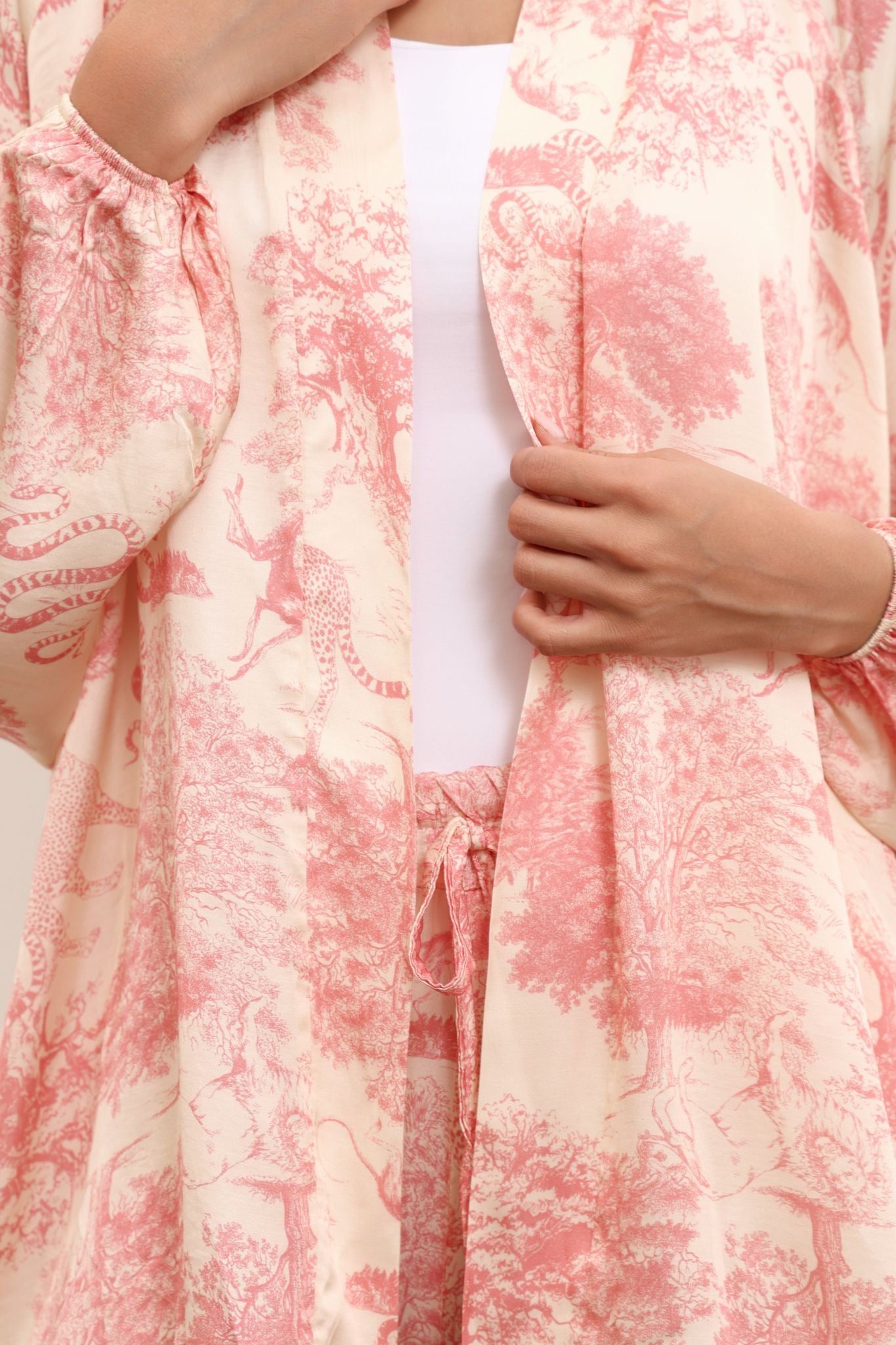 Close-up of a pink and white patterned garment with a person wearing it.