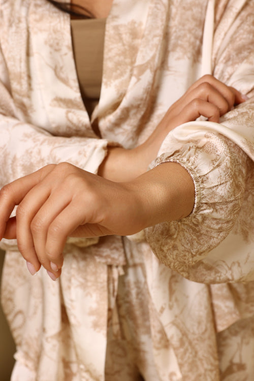 Close-up of a person wearing a patterned robe with a focus on the fabric and texture.