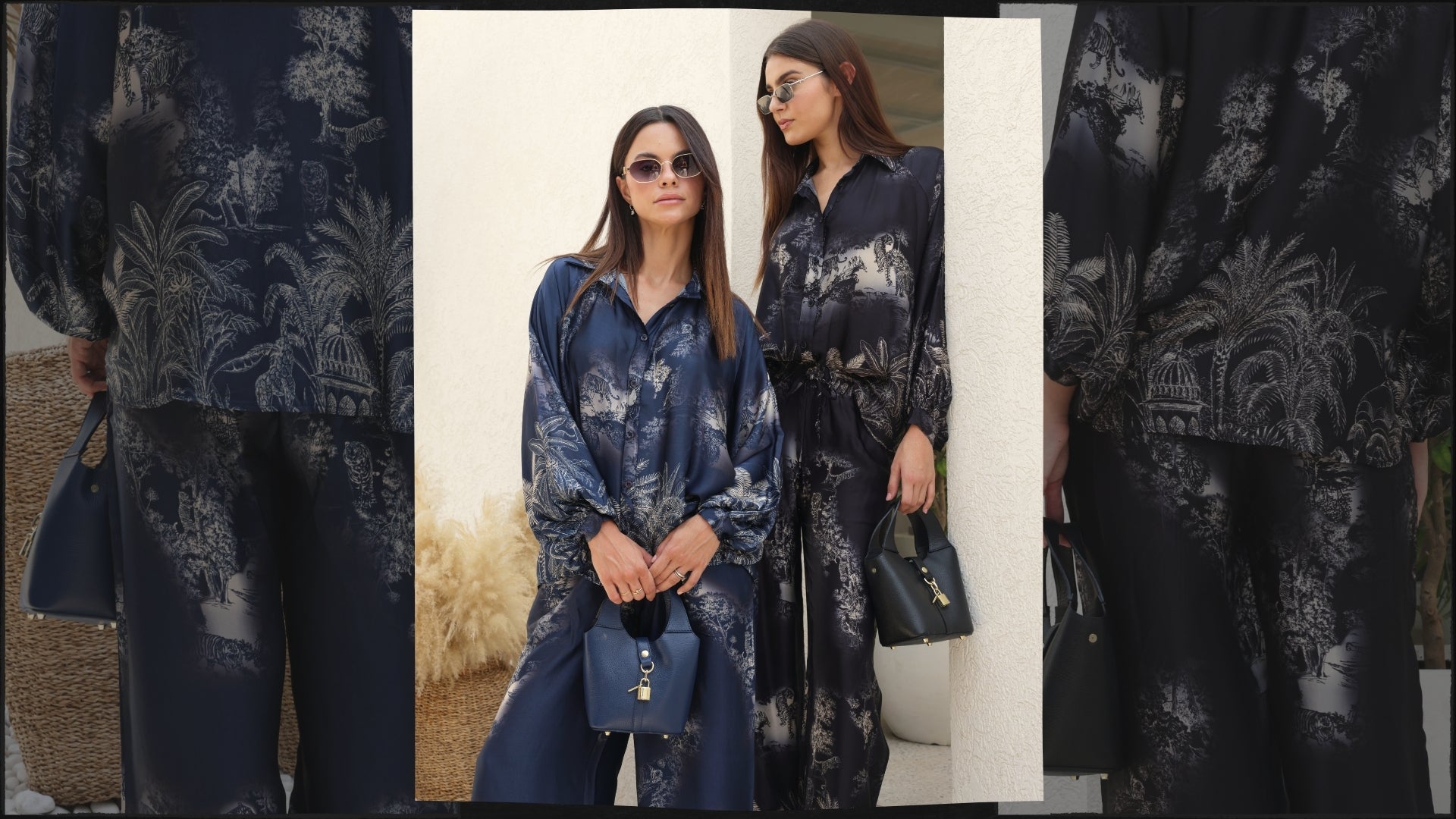 Two women wearing matching blue and black floral outfits standing in a neutral setting.